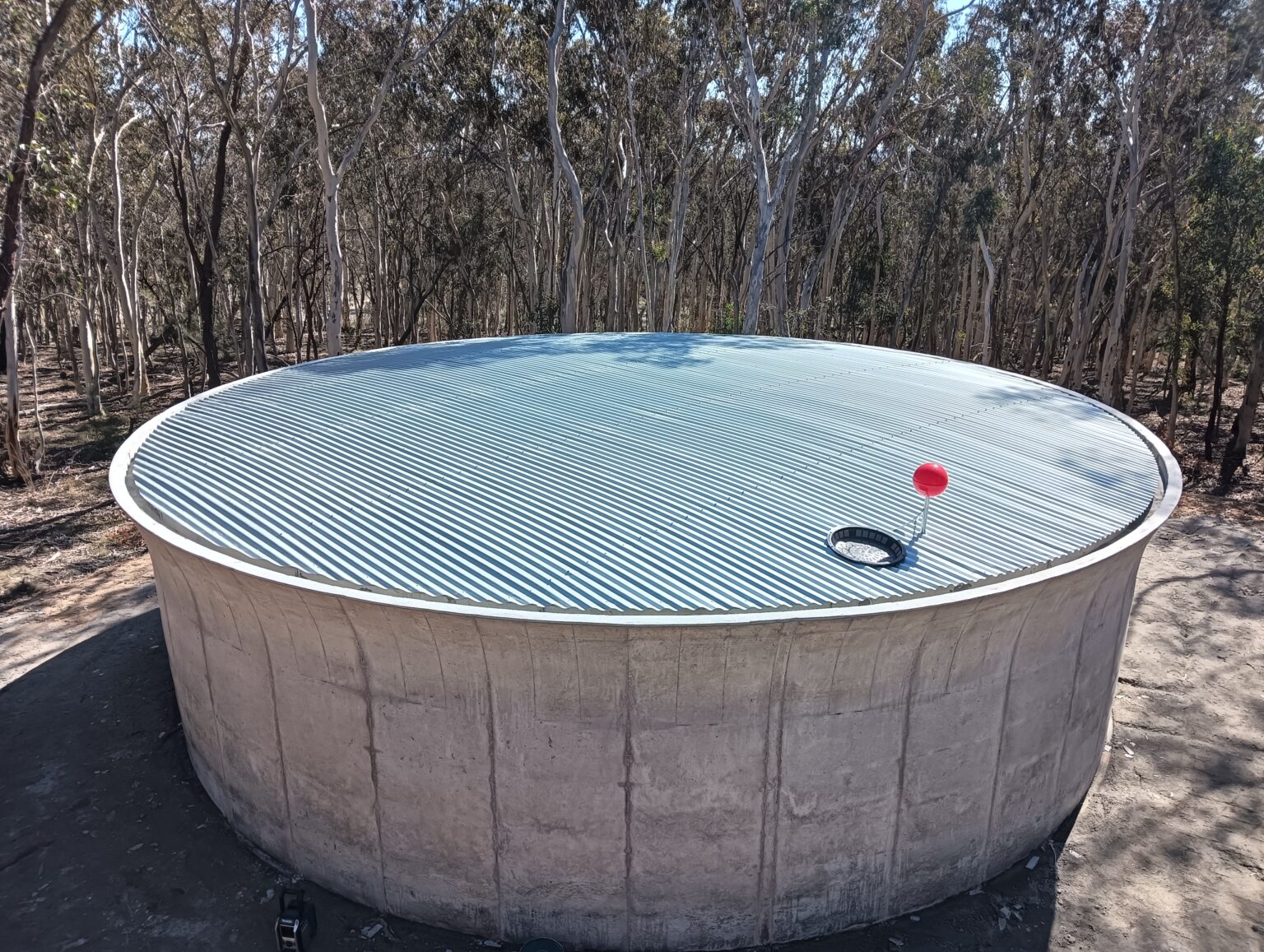 a concrete tank with a tin roof