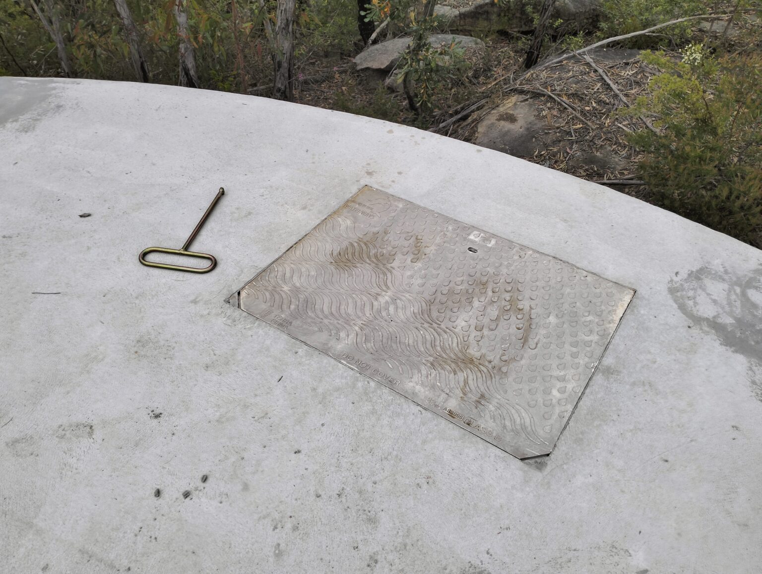 a class b pit lid on a concrete tank